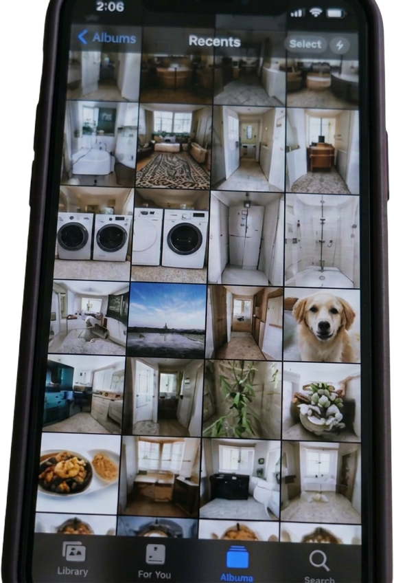 A phone showing a crowded camera roll of photos